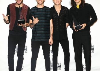 Liam Payne and Niall Horan congratulate Harry Styles on winning Album of the Year Grammy