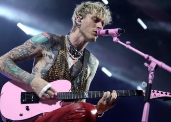 Watch Machine Gun Kelly punch a fan in the face on request