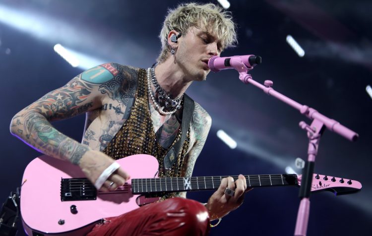 Watch Machine Gun Kelly punch a fan in the face on request