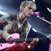 Watch Machine Gun Kelly punch a fan in the face on request